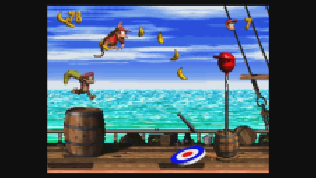 Diddy Kong jumping across a ship deck toward bananas and an enemy in Donkey Kong Country 2
