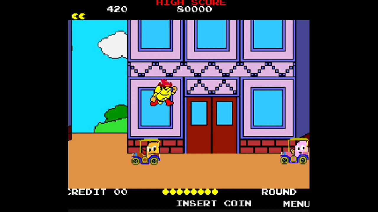 PAC-MAN running past buildings and roadside enemies in the side-scrolling PAC-LAND