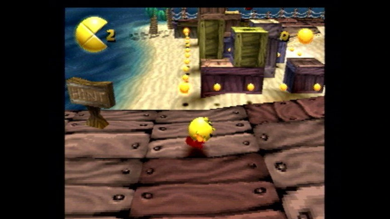 PAC-MAN running along Buccaneer Beach while collecting PAC-Dots in the original PlayStation game