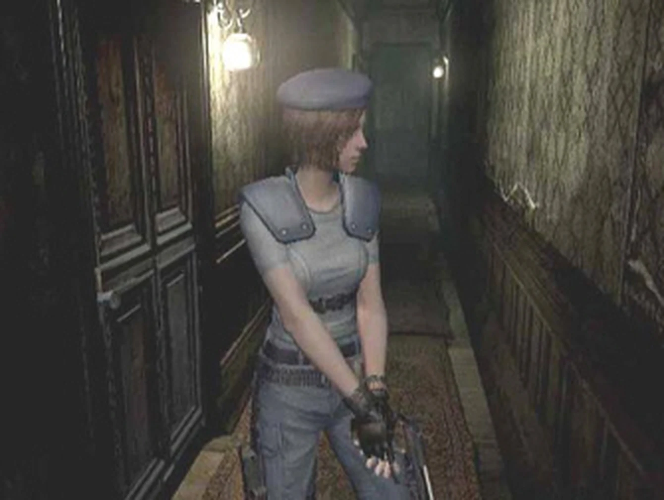 Jill Valentine explores a dimly lit Spencer Mansion hallway in a fixed-camera gameplay view