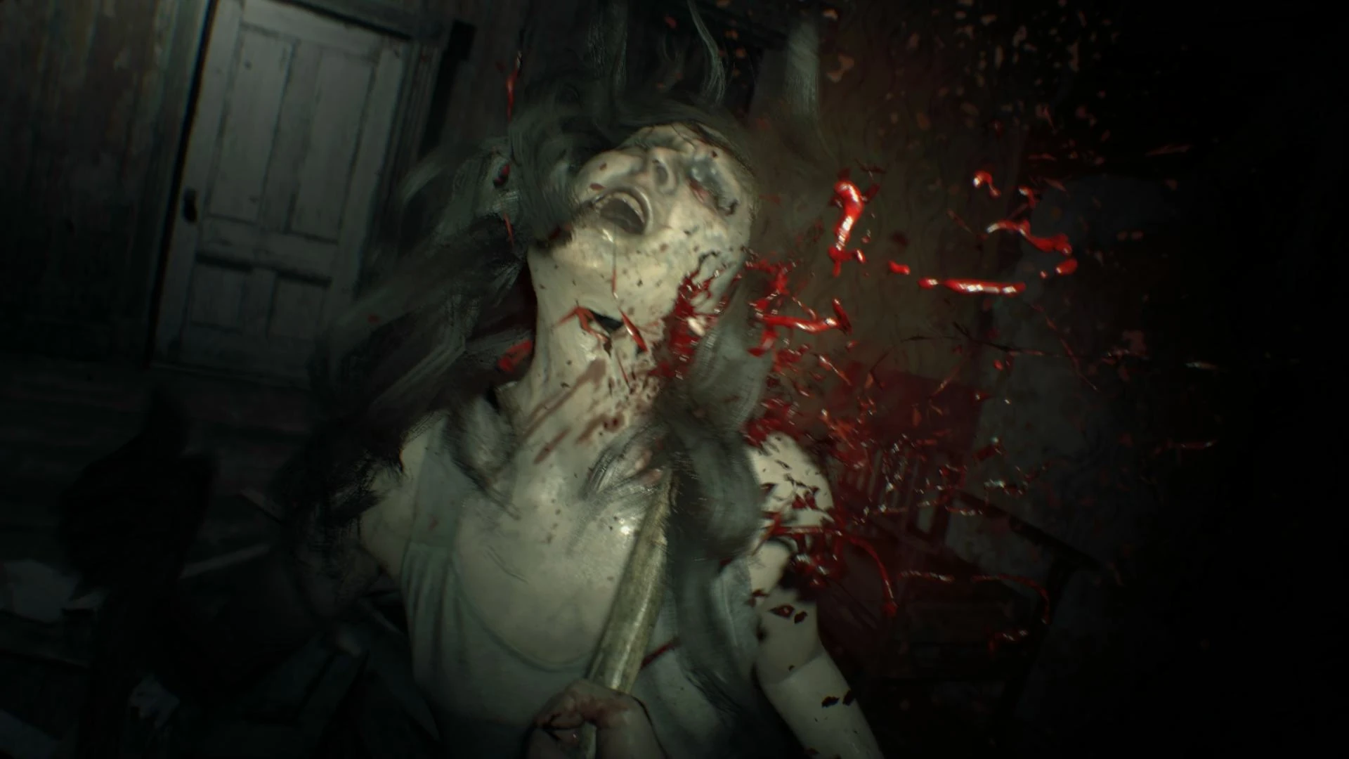 A first-person gameplay view down a decaying Baker house corridor with a handgun and ammunition counter visible