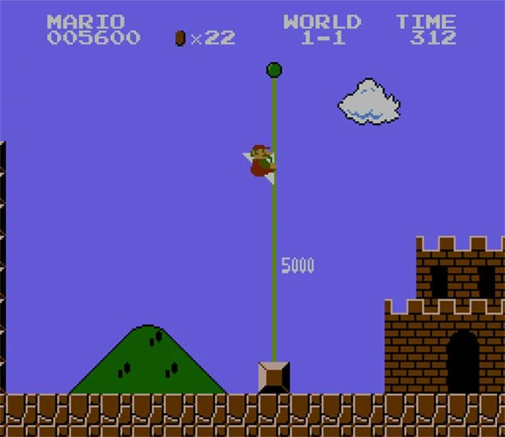 Mario sliding down the World 1-1 flagpole with the score and timer visible in Super Mario Bros.