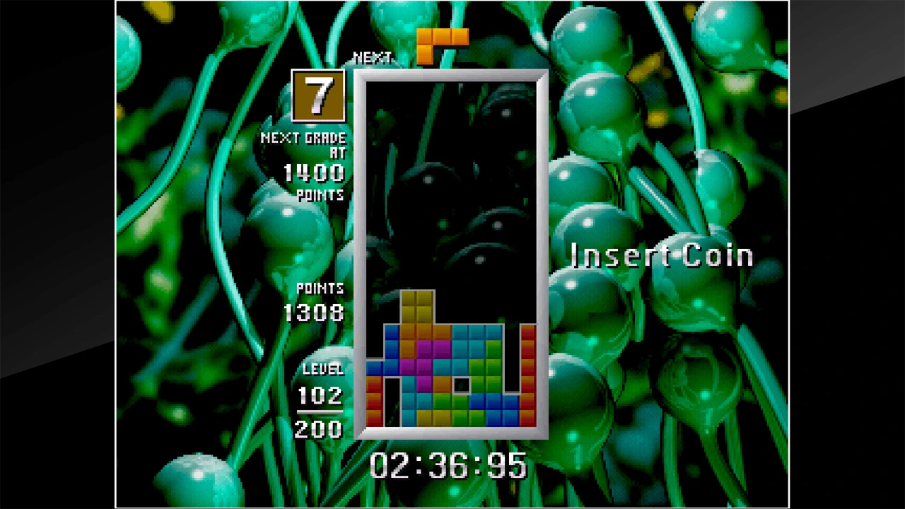 A Tetris: The Grand Master run with the grade, time, level, and stacked playfield visible